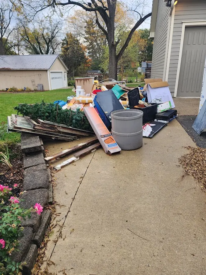 Dumpster being loaded with debris for Estate Cleanout Dumpster Rental in Rockaway